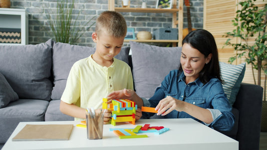 Mother and son building with colorful blocks together.
